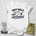 White -shirt with 'Why walk when you can cartwheel' text, socks, and drawstring bag on a light wooden surface.