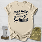 Beige t-shirt with 'Why walk when you can cartwheel' text, socks, and drawstring bag on a light wooden surface.