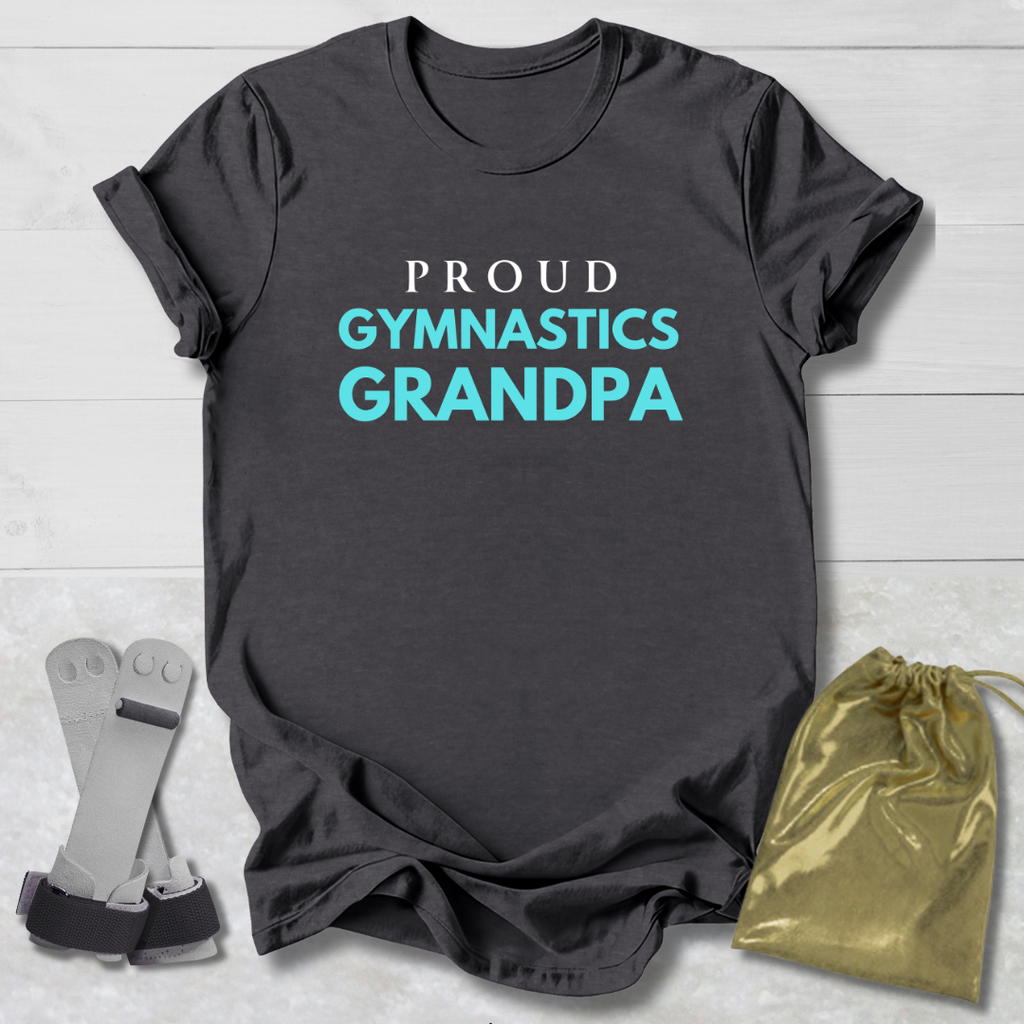 Gray t-shirt with 'Proud Gymnastics Grandpa' text, socks, and drawstring bag on a light wooden surface