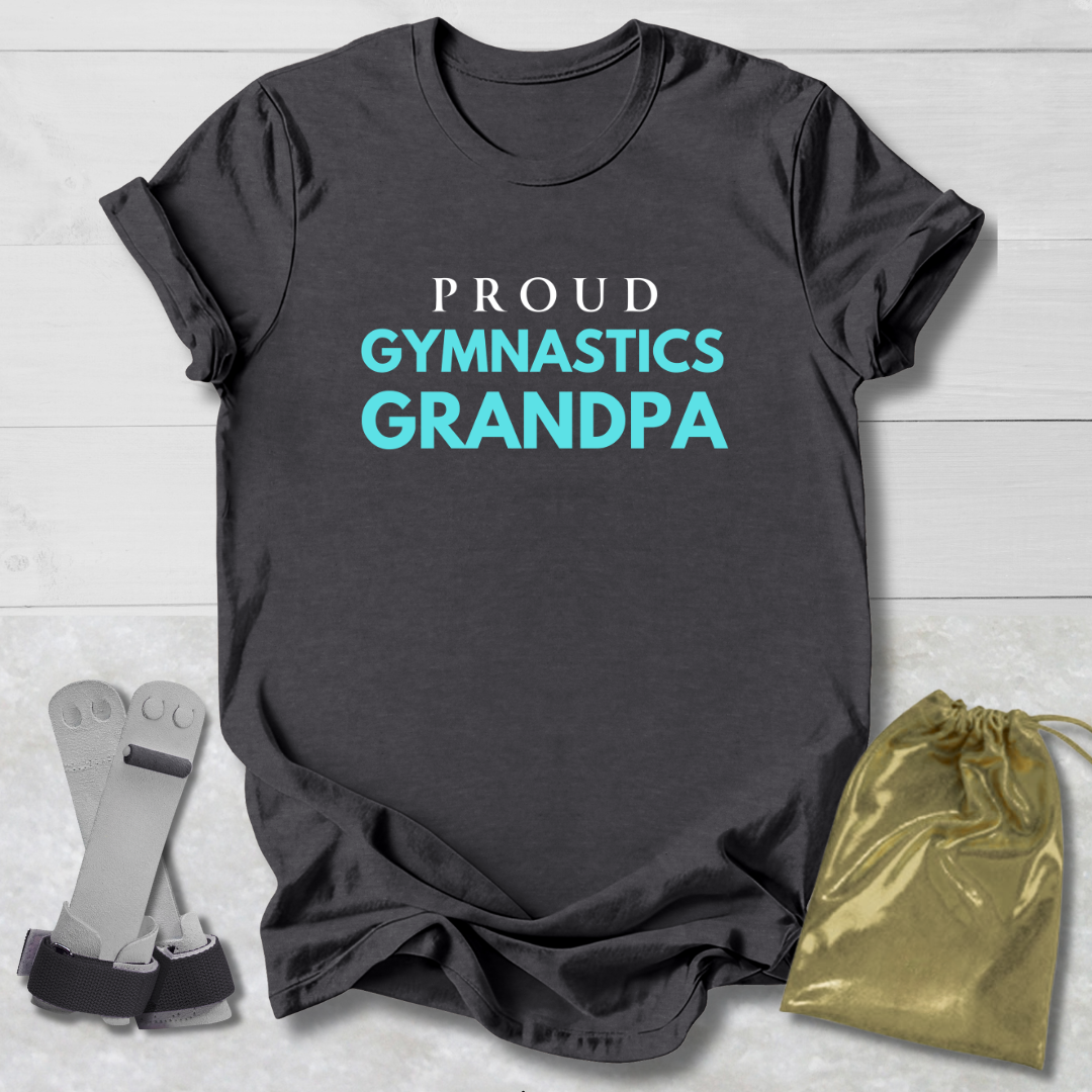 Gray t-shirt with 'Proud Gymnastics Grandpa' text, socks, and drawstring bag on a light wooden surface