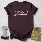 Maroon t-shirt with 'Gymnastics grandma' text, socks, and drawstring bag on a light wooden surface