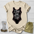 Beige t-shirt with black funny gymnastics leotard graphic and text, socks, and drawstring bag on a light wooden surface.