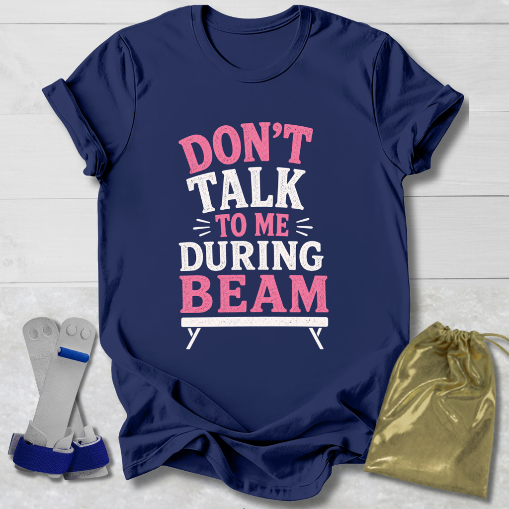 Navy blue t-shirt with 'Don't talk to me during beam' text on a light wooden surface.