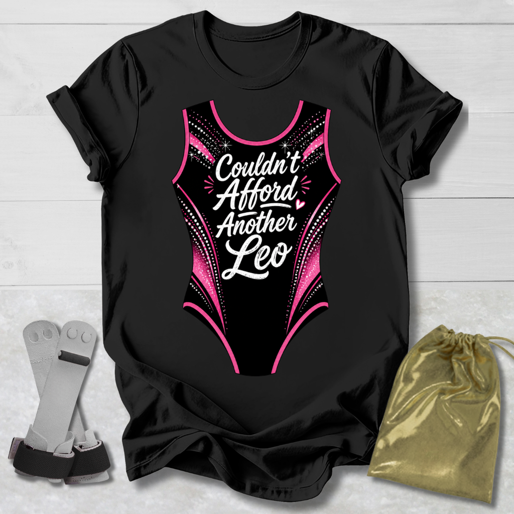 Black t-shirt with a funny gymnastics leotard  graphic and text, socks, and a drawstring bag on a light wooden surface.