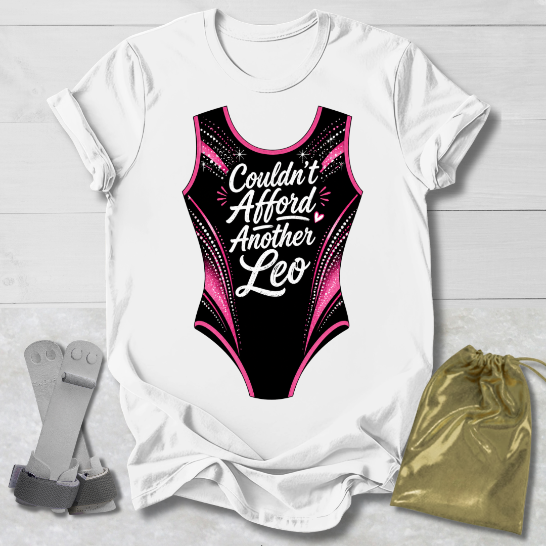 White t-shirt with a funny gymnastics leotard  graphic and text, socks, and a drawstring bag on a light wooden surface.