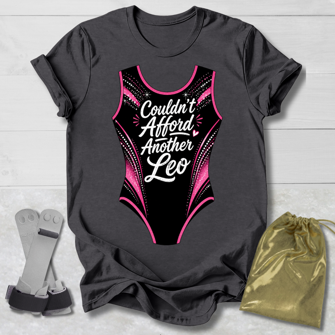 Gray t-shirt with a funny gymnastics leotard  graphic and text, socks, and a drawstring bag on a light wooden surface.