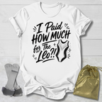 White t-shirt with I paid how much for the gymnastics leotard?!  text and graphic, socks, and drawstring bag on a light wooden surface