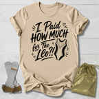 Beige t-shirt with I paid how much for the gymnastics leotard?!  text and graphic, socks, and drawstring bag on a light wooden surface