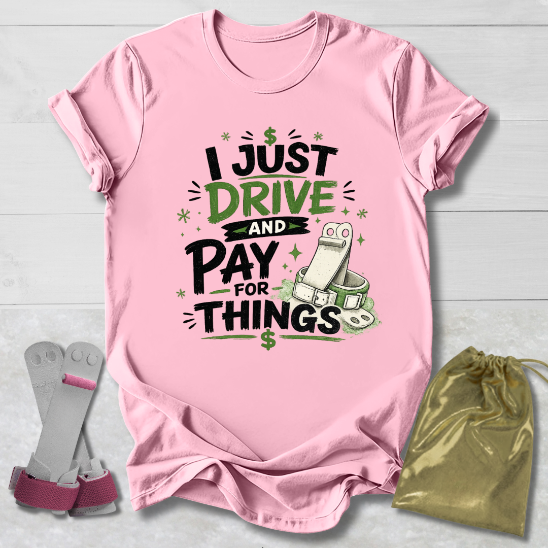 Pink t-shirt with humorous  I drive and pay for things gymnastics mom and dad text design on a light wooden surface, accompanied by socks and a drawstring bag.