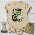 Beige t-shirt with humorous I drive and pay for things gymnastics mom and dad text design on a light wooden surface, accompanied by socks and a drawstring bag. 