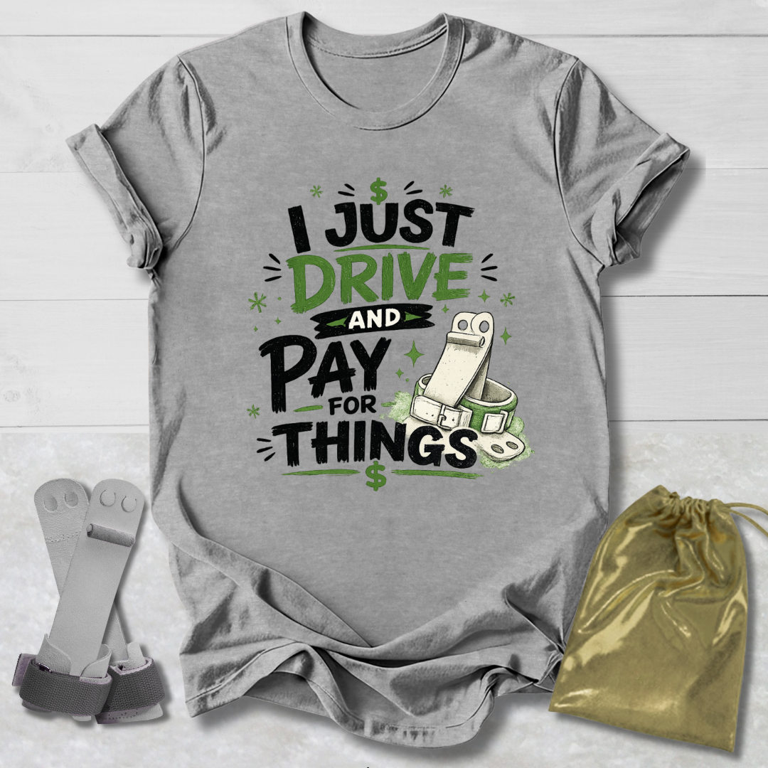 Gray t-shirt with humorous  I drive and pay for things gymnastics mom and dad text design on a light wooden surface, accompanied by socks and a drawstring bag.
