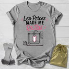Gray t-shirt with graphic design and Leotard prices made me do this gymnastics text, placed on a light wooden surface with socks and a drawstring bag.
