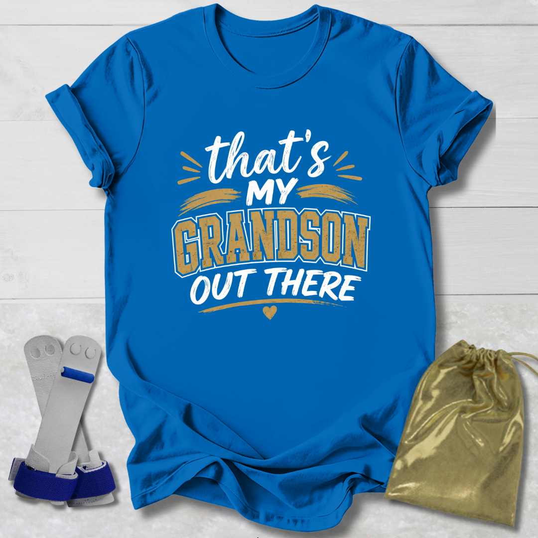 Blue t-shirt with 'That's my grandson out there' text, socks, and drawstring bag on a light wooden surface