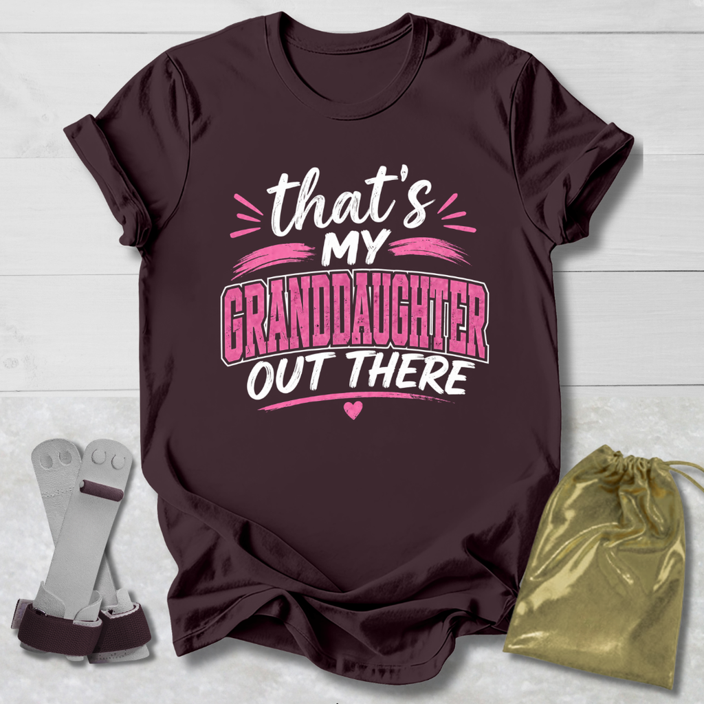 Maroon t-shirt with 'That's my granddaughter out there' text on a light wooden surface.