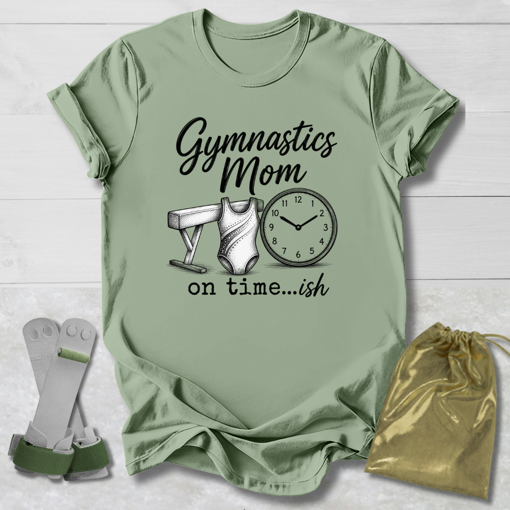 Green t-shirt with 'Gymnastics Mom on time...ish' text and graphics, socks, and drawstring bag on a light wooden surface.