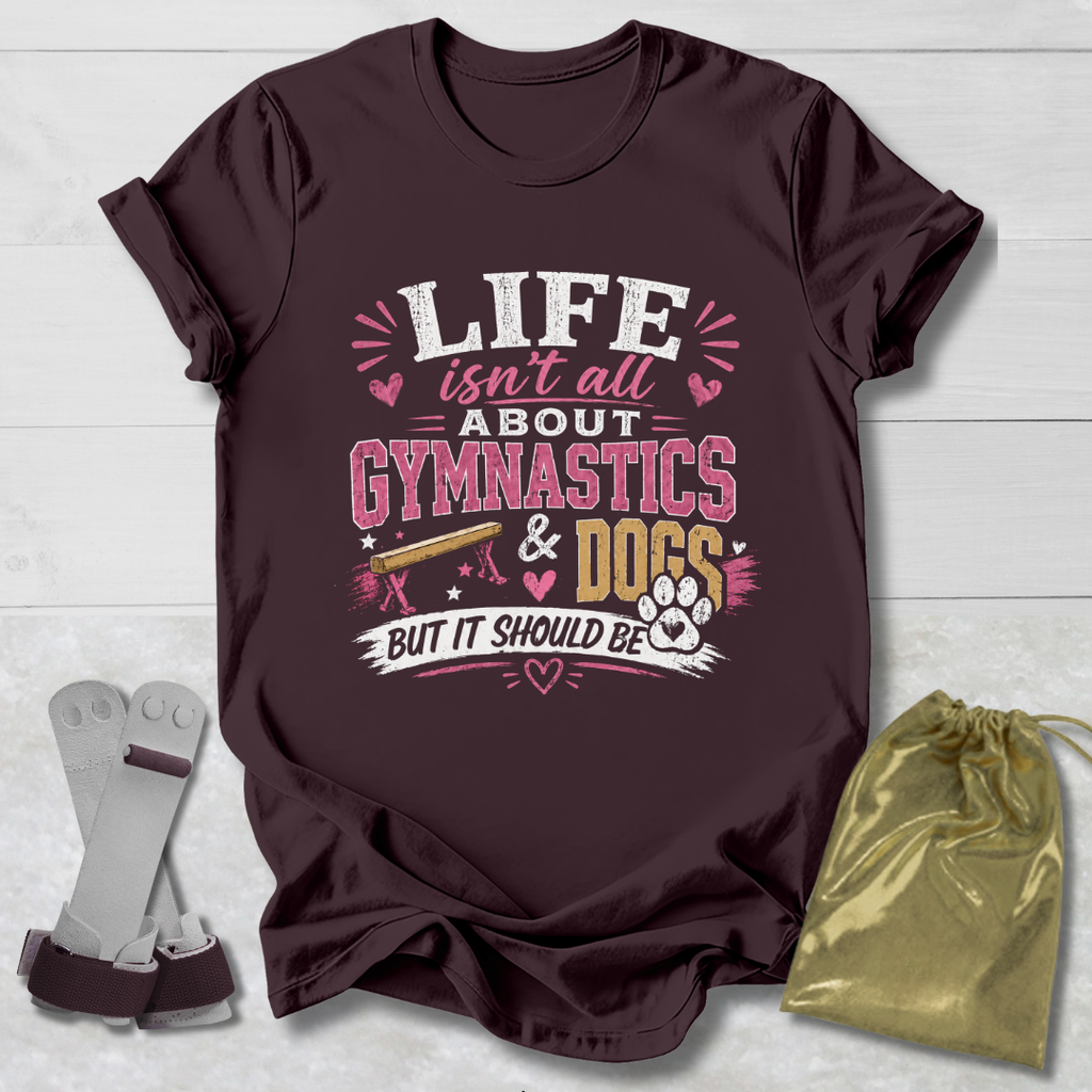 Maroon t-shirt with 'Life isn't all about Gymnastics & Dogs but it should be' text on a light wooden surface.