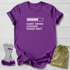 Purple t-shirt with humorous text design, socks, and drawstring bag on a light wooden surface.
