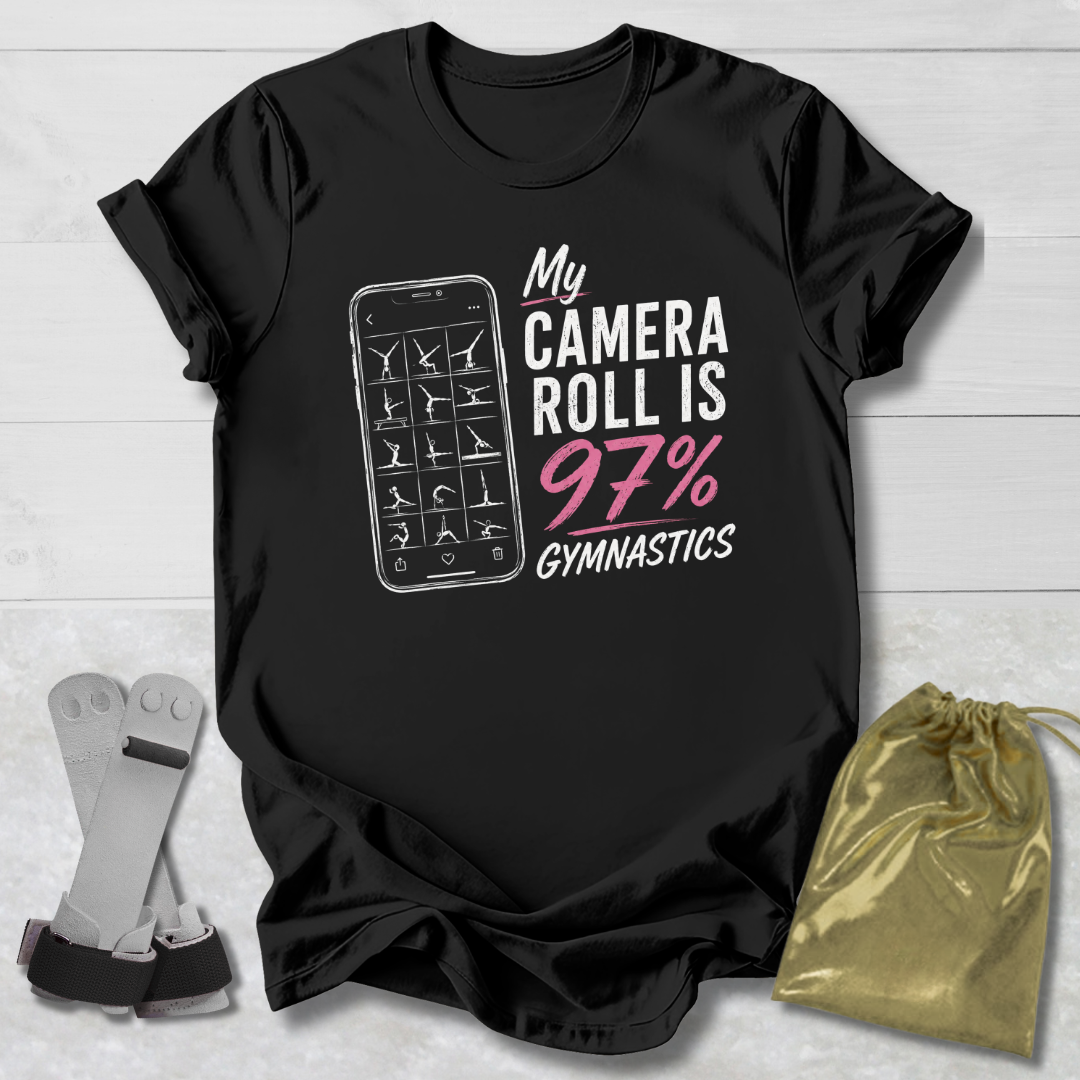Black t-shirt with graphic and text on a light wooden surface, with socks and a drawstring bag in the foreground.