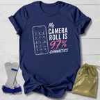 Navy blue t-shirt with 'My Camera Roll is 97% Gymnastics' design on a light wooden surface.