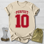 Beige t-shirt with red 'PERFECT 10' print, socks, and drawstring bag on a light wooden surface.