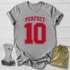 Gray t-shirt with 'PERFECT 10' in red, socks, and a drawstring bag on a light wooden surface.