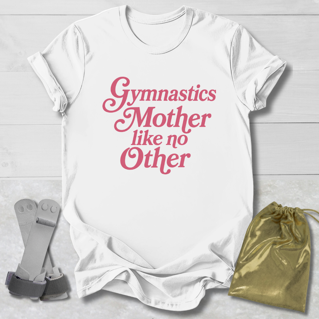 White t-shirt with pink text 'Gymnastics Mother like no Other' on a light wooden surface with socks and a drawstring bag.