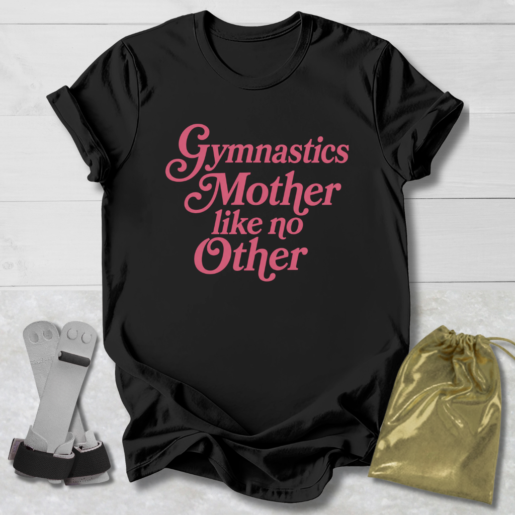 Black t-shirt with pink text 'Gymnastics Mother like no Other' on a light wooden surface.