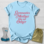 Light blue t-shirt with 'Gymnastics Mother like no Other' text, socks, and drawstring bag on a light wooden surface.