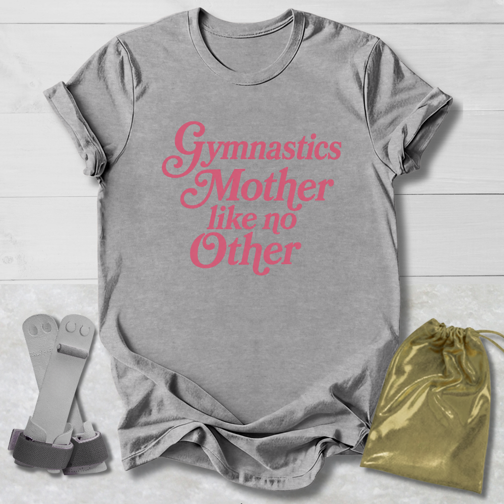 Gray t-shirt with pink text 'Gymnastics Mother like no Other' on a light wooden surface, with socks and a drawstring bag.