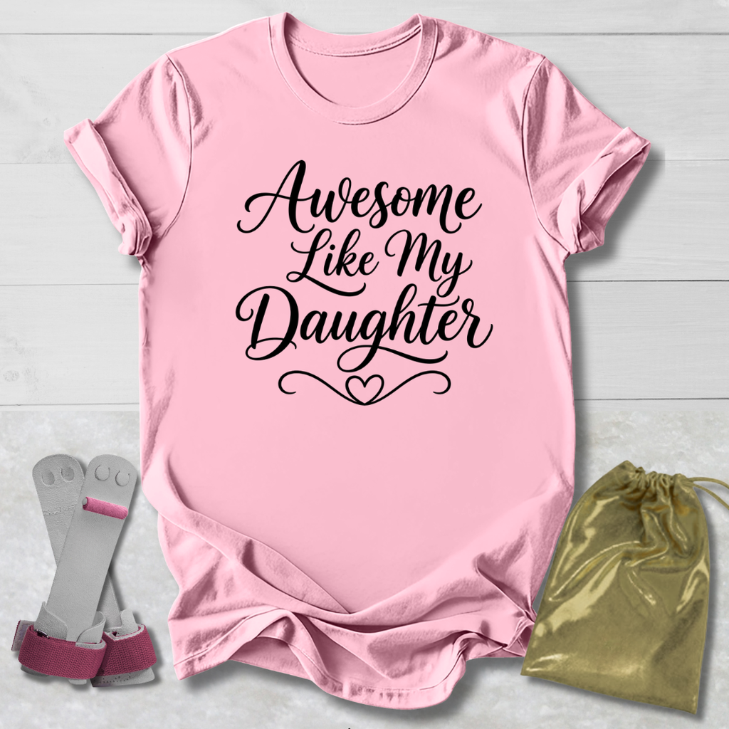 Pink t-shirt with 'Awesome Like My Daughter' text, socks, and drawstring bag on a light wooden surface.