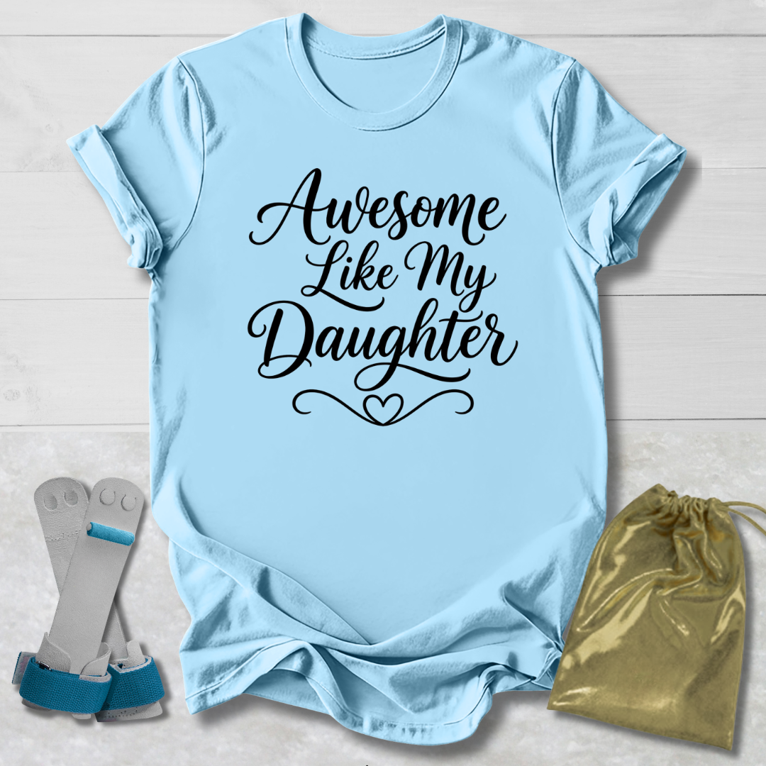 Light blue t-shirt with 'Awesome Like My Daughter' text, socks, and drawstring bag on a light wooden surface.