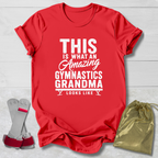 Red t-shirt with white text 'This is what an amazing gymnastics grandma looks like' on a light wooden surface.