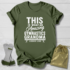 Green t-shirt with text 'This is what an amazing gymnastics grandma looks like' on a wooden surface.