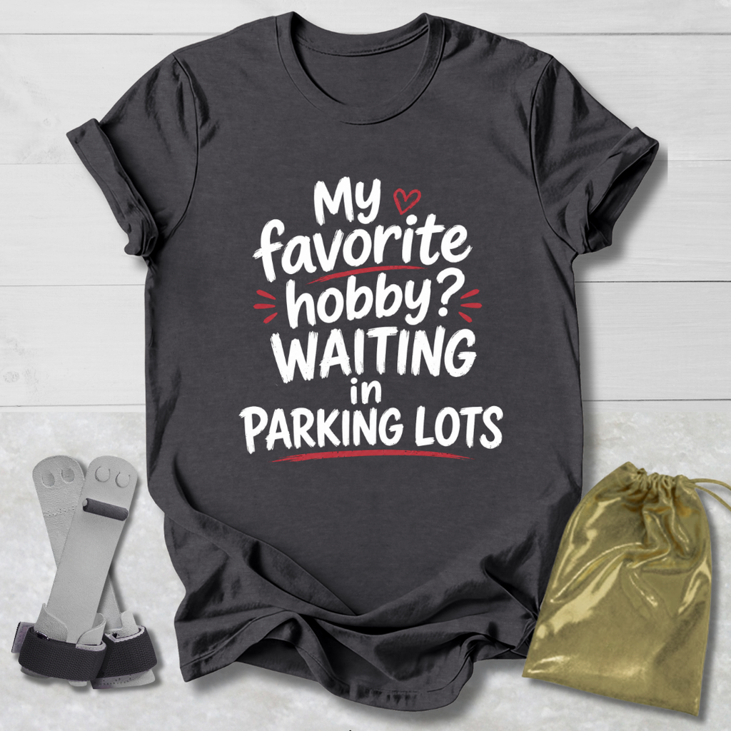 Dark gray t-shirt with humorous text design on a light wooden surface.