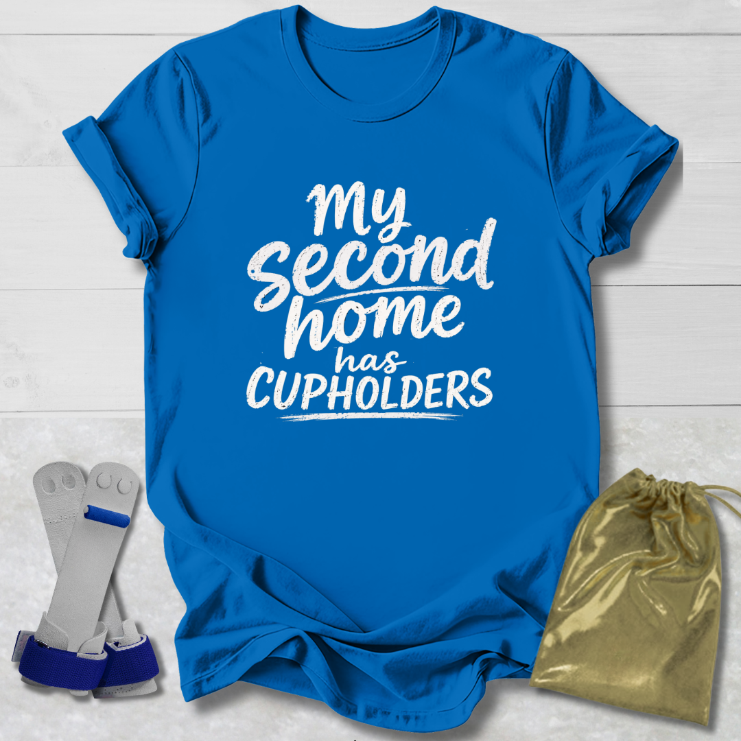 Blue t-shirt with 'My second home has cupholders' text, socks, and drawstring bag on a light wooden surface.