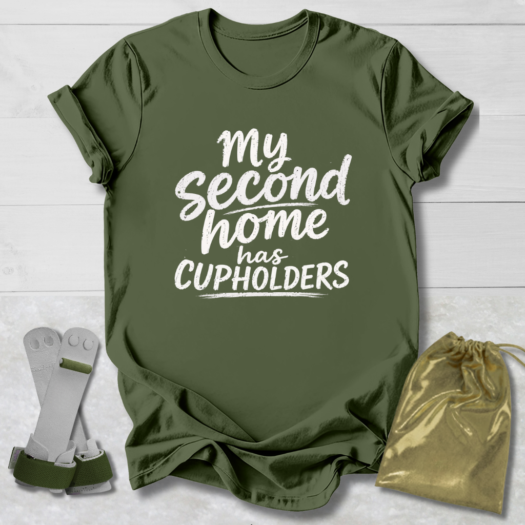 Green t-shirt with 'My second home has cupholders' text, socks, and drawstring bag on a light wooden surface.