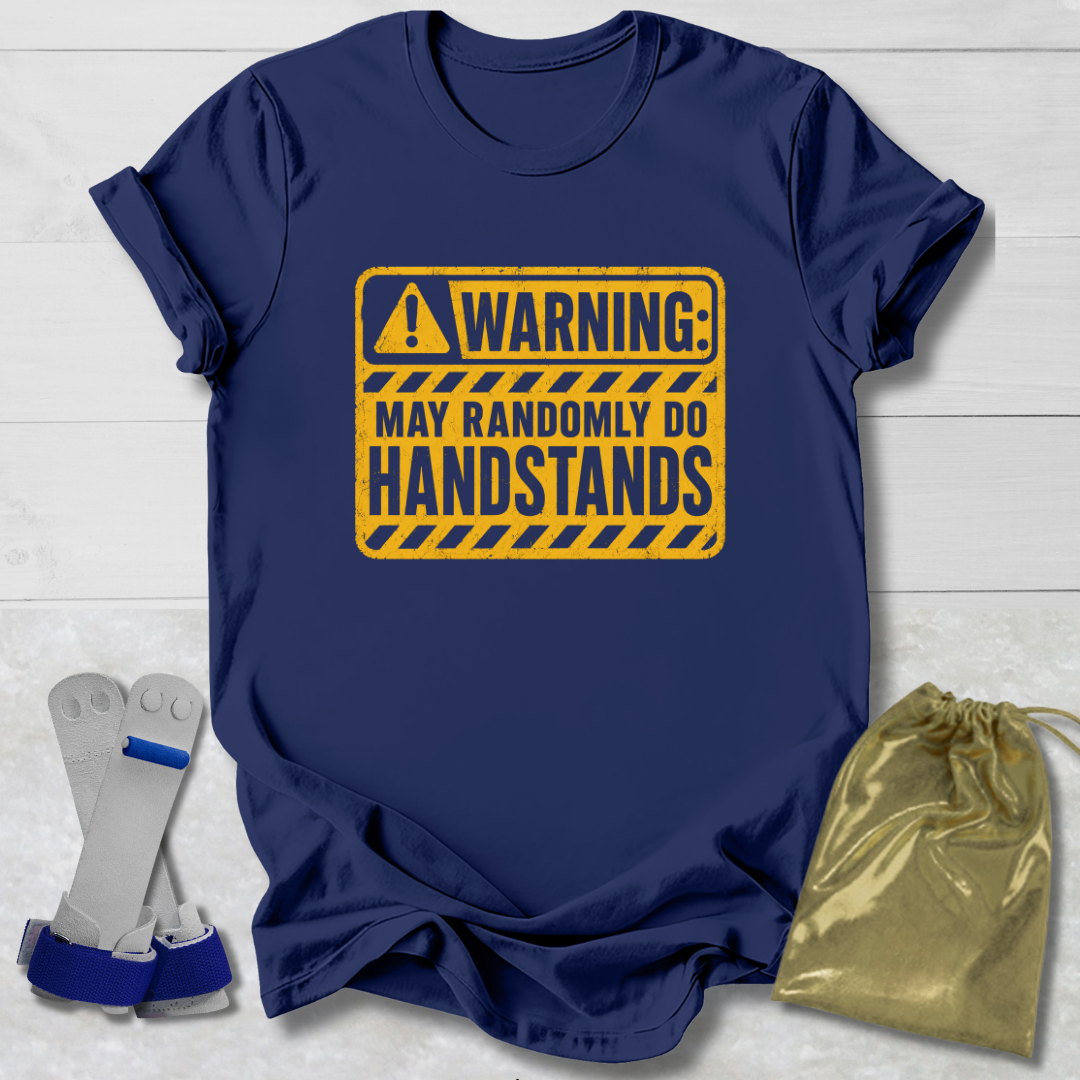 Navy blue t-shirt with yellow warning sign graphic on a light wooden surface.