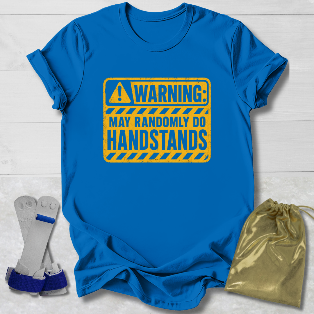 Blue t-shirt with a yellow warning sign graphic, socks, and a drawstring bag on a light wooden surface.