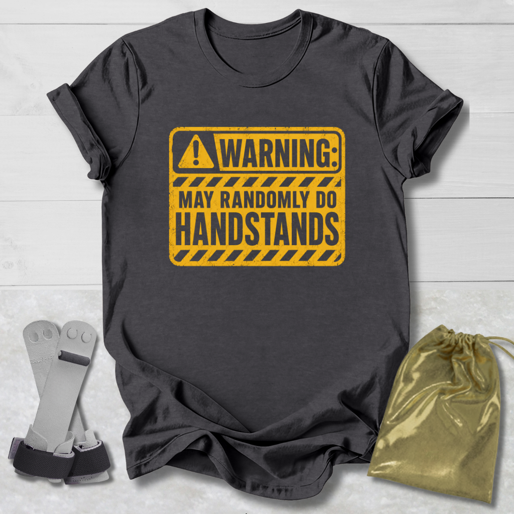 Gray t-shirt with yellow warning sign graphic on a light wooden surface