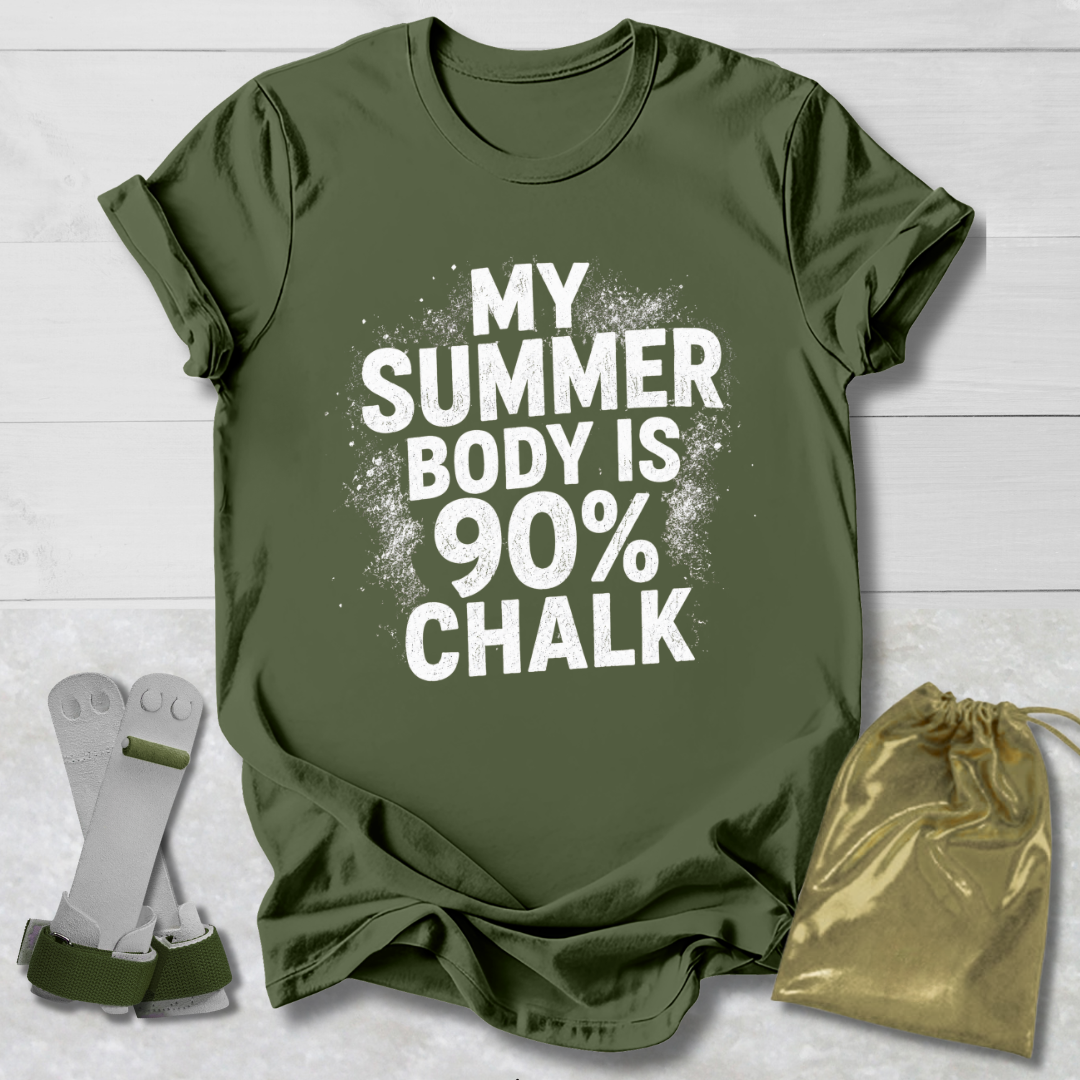Green t-shirt with 'My Summer Body is 90% Chalk' text on a wooden surface with socks and a drawstring bag.