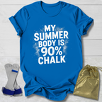 Blue t-shirt with 'My Summer Body is 90% Chalk' text on a light wooden surface, with socks and a drawstring bag in the foreground.