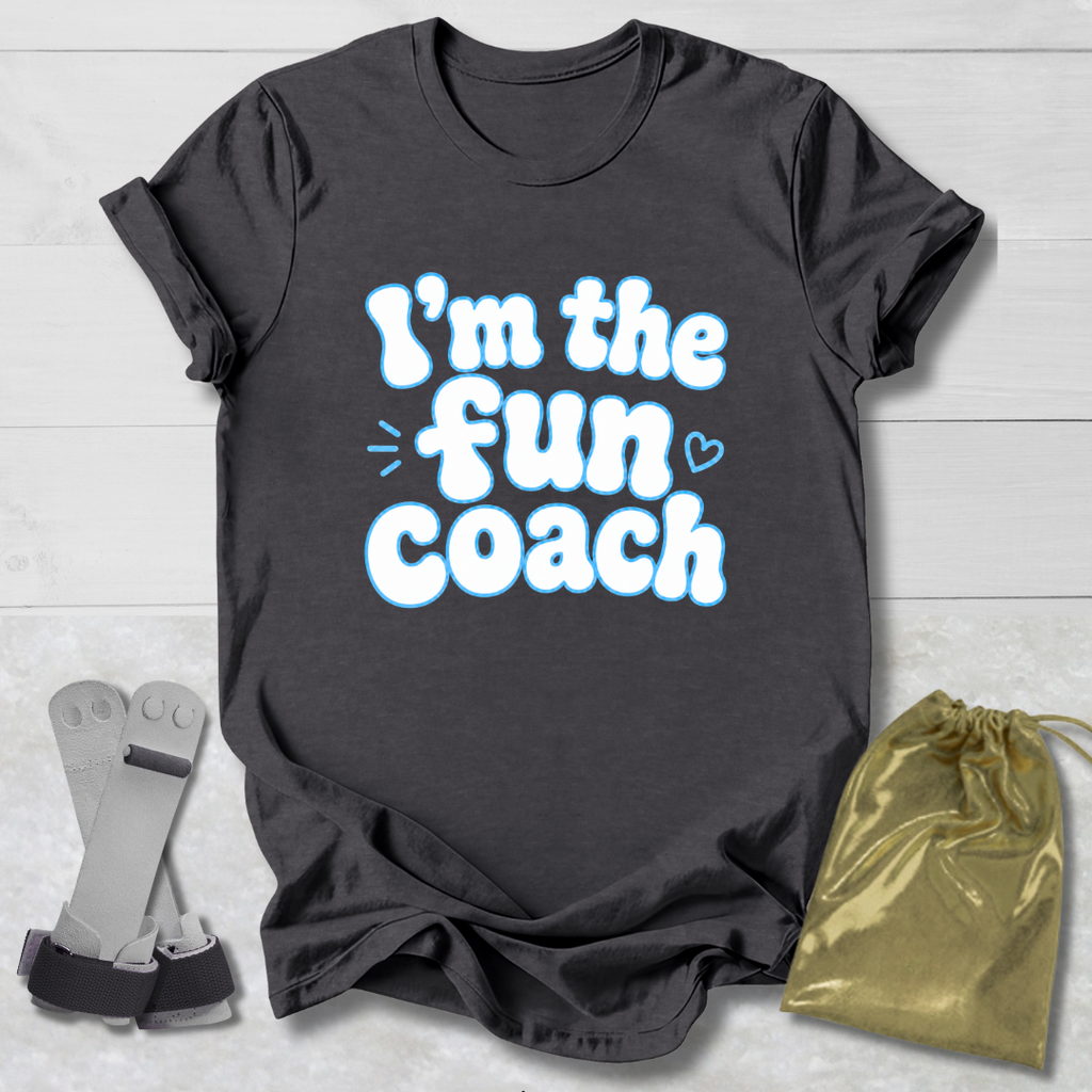 Gray t-shirt with 'I'm the fun coach' text, socks, and drawstring bag on a light wooden surface