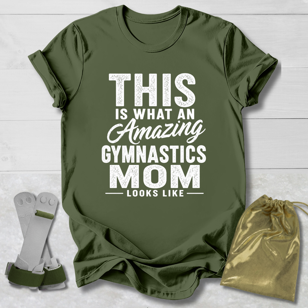 Green t-shirt with text 'This is what an amazing gymnastics mom looks like' on a wooden surface with socks and a drawstring bag.