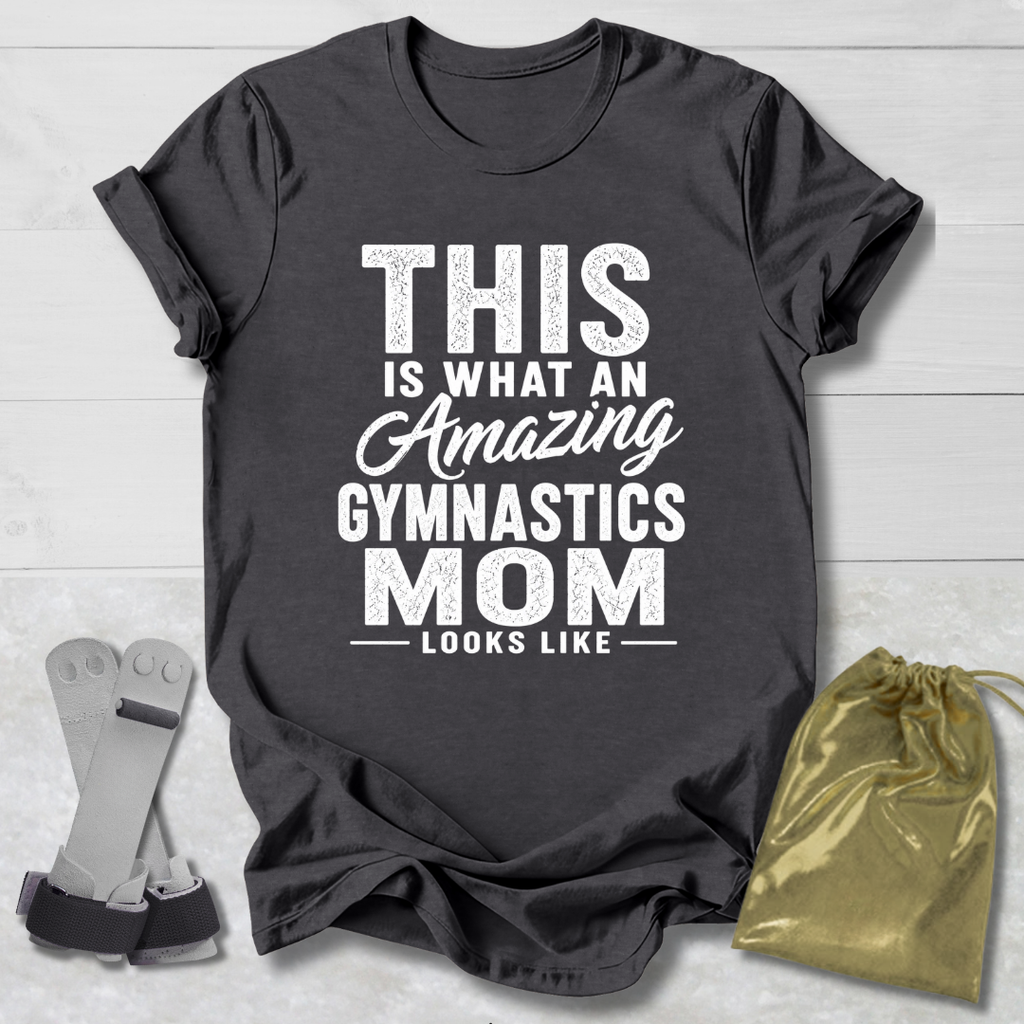 Black t-shirt with 'Amazing Gymnastics Mom' text on a light wooden surface with socks and a drawstring bag.