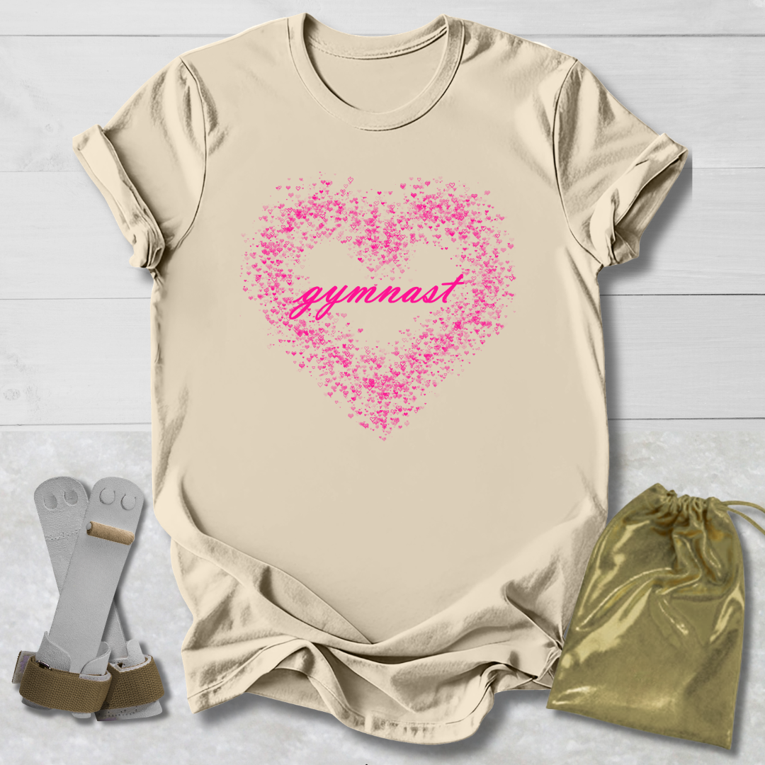 Beige t-shirt with pink heart and 'gymnast' text, socks, and drawstring bag on a light wooden surface