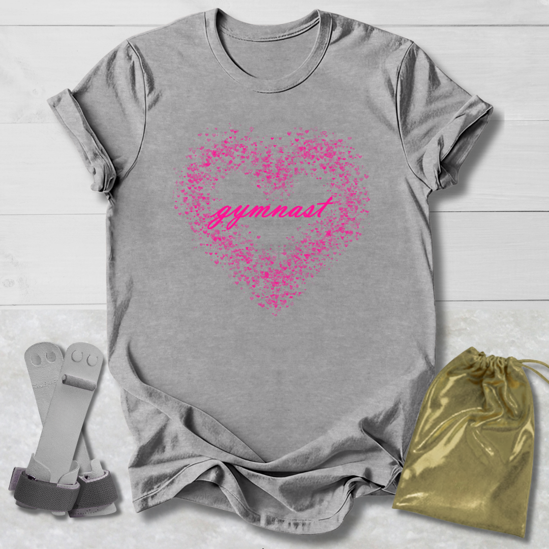 Gray t-shirt with pink heart and 'gymnast' text, socks, and drawstring bag on a light wooden surface