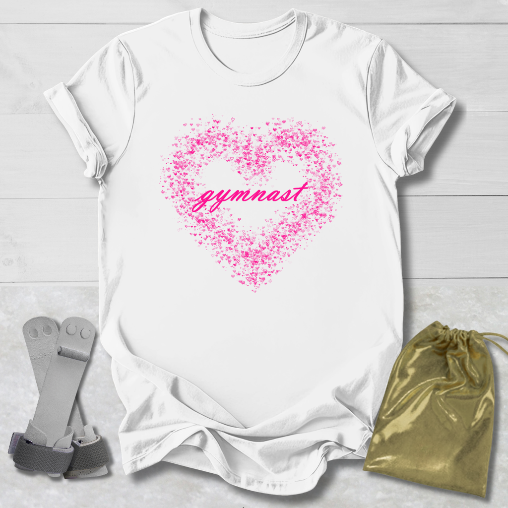 White t-shirt with pink heart and 'gymnast' text, socks, and drawstring bag on a light wooden surface