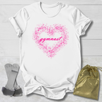 White t-shirt with pink heart and 'gymnast' text, socks, and drawstring bag on a light wooden surface