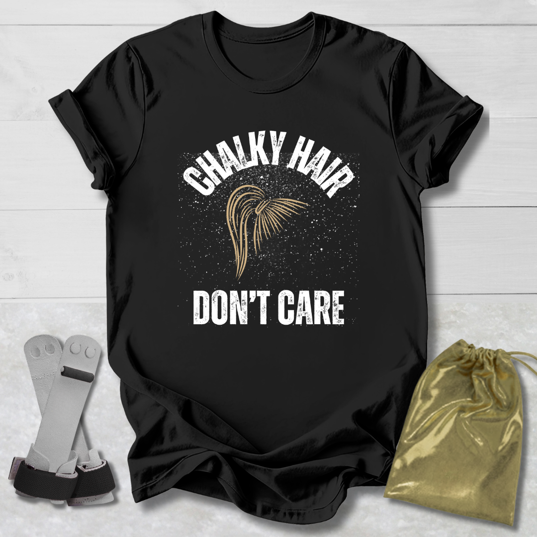 Black t-shirt with 'Chalky Hair Don't Care' text and graphics on a wooden surface.