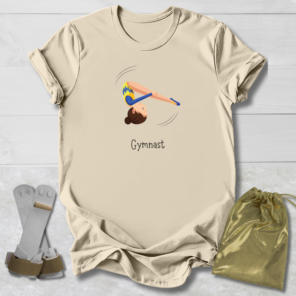 Beige t-shirt with gymnast design and text, socks, and drawstring bag on a light wooden surface